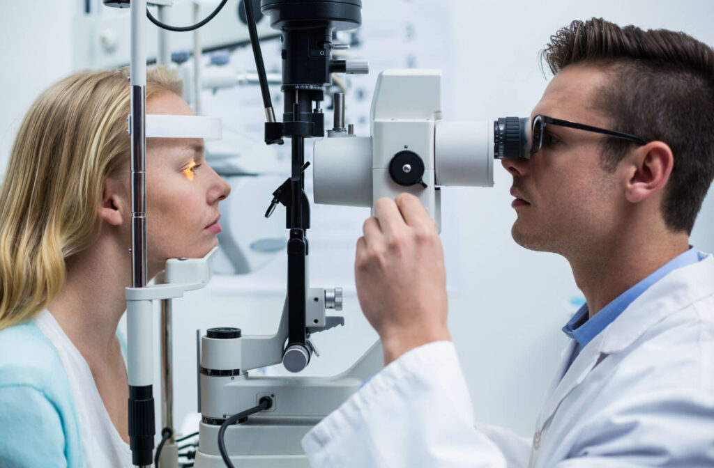 A woman receiving an eye exam from her male optometrist.
