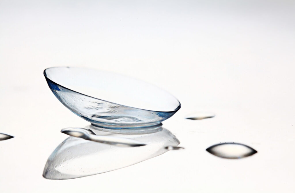 A contact lens sitting on a clear surface.