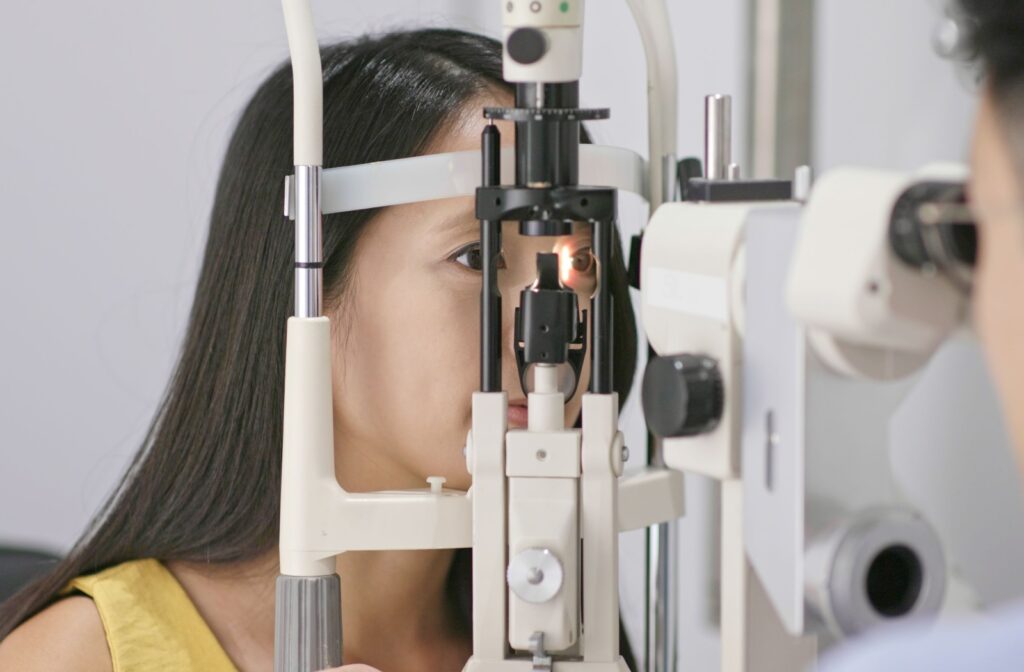 A woman at the eye doctor having her eyes examined by an eye doctor to see if she's a candidate for overnight contact lenses.