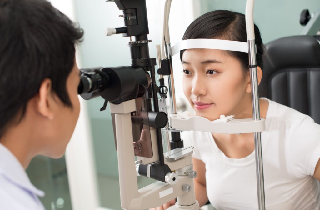 A patient at the eye doctor having their eyes examined with a slit lamp.
