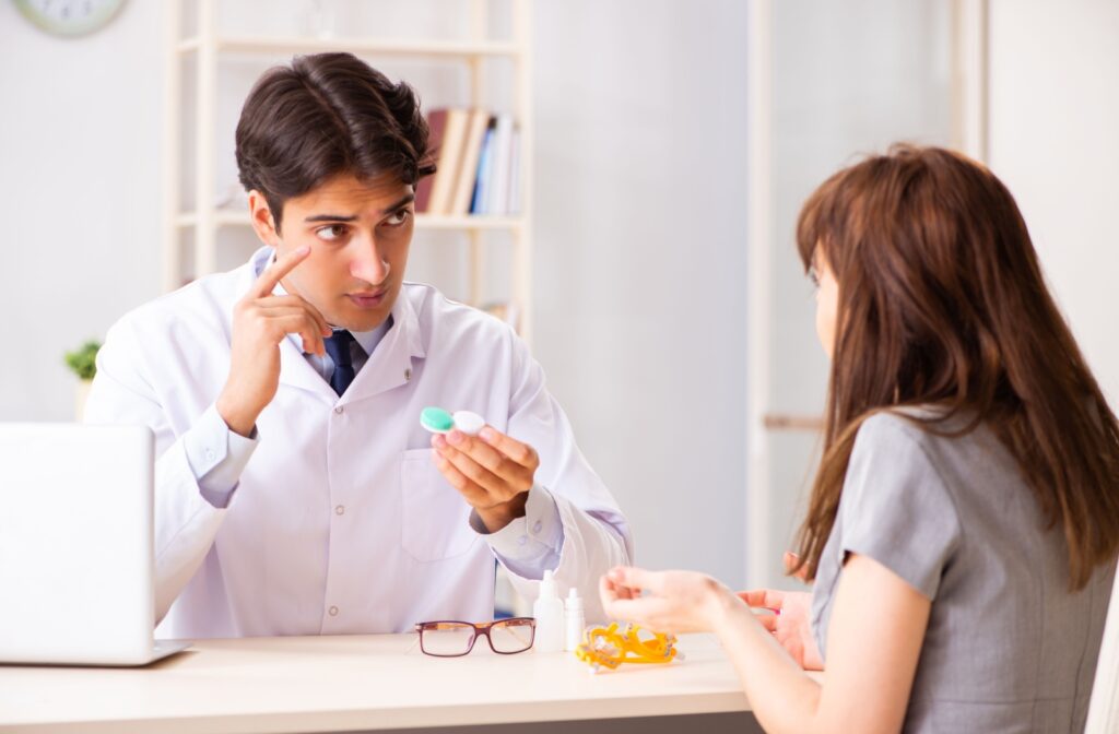 A young woman learns about proper ortho-k leans wear and care with her optometrist.