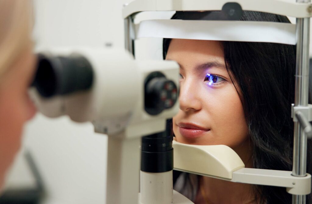 A patient has their eye examined with a slit lamp during an eye exam.